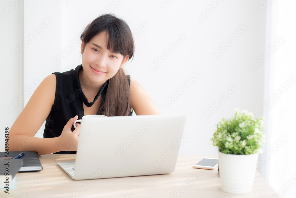 Beautiful freelance asian woman smiling working and typing on laptop computer at desk office with professional, girl using notebook checking email or social network, business and lifestyle concept. Beautiful freelance asian woman smiling working and typing on laptop computer at desk office with professional, girl using notebook checking email or social network, business and lifestyle concept.