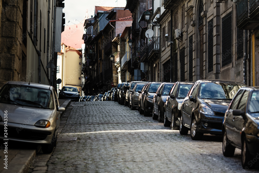 Cars parked along the pavement streets of the old town.
