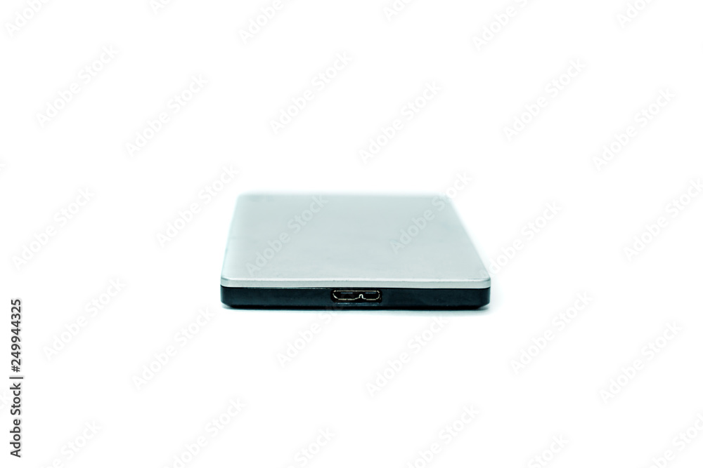 Gray portable hard drive. The concept of data storage on an external medium. Backing up files, protecting files. Gray portable hard drive. The concept of data storage on an external medium. Backing up files, protecting files.
