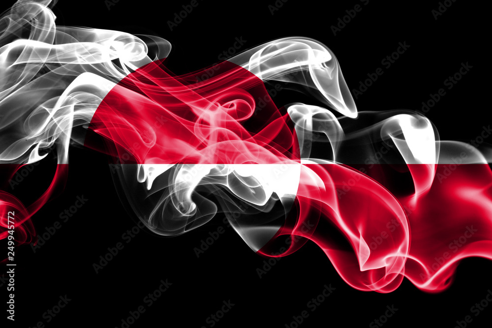 Fototapeta premium National flag of Greenland made from colored smoke isolated on black background. Abstract silky wave background.