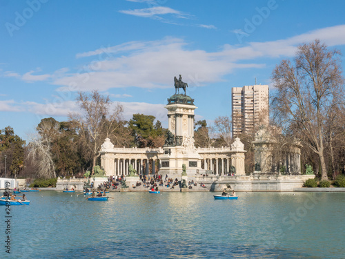 People enjoying a boat ride on the pond in El Retiro Park in Madrid, Spain.