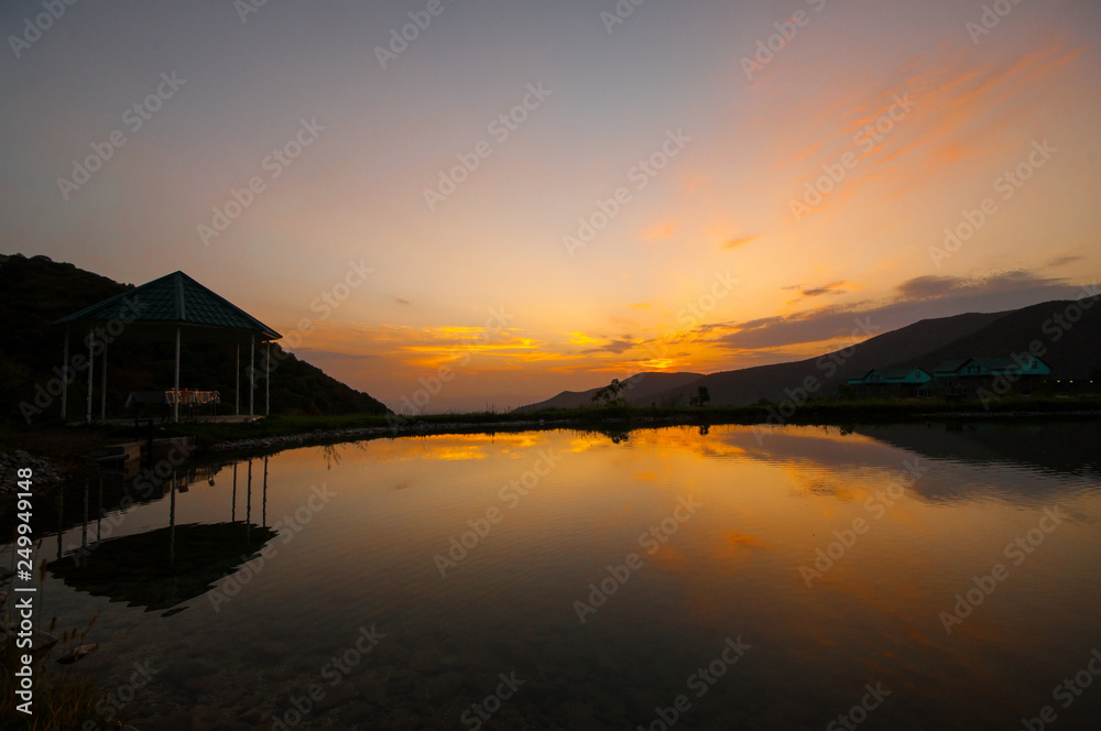 Fototapeta premium Beautiful clouds flying over the lake near mountains. Evening time shot over the clouds. Azerbaijan. Big Caucasus