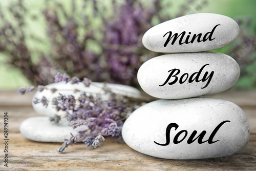 Spa stones with lavender flowers on table