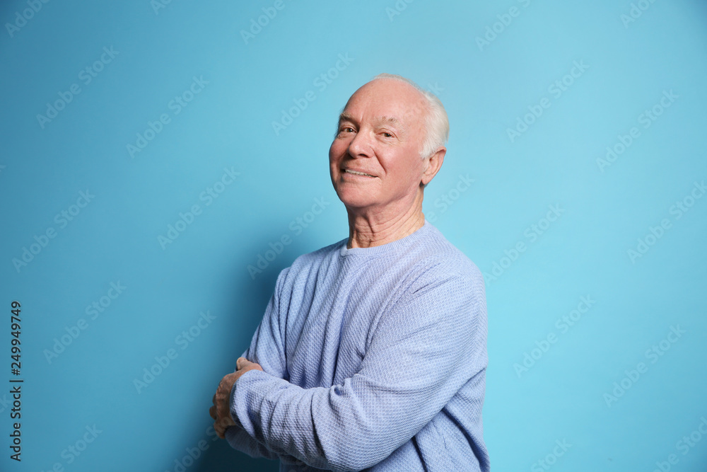Portrait of elderly man on color background