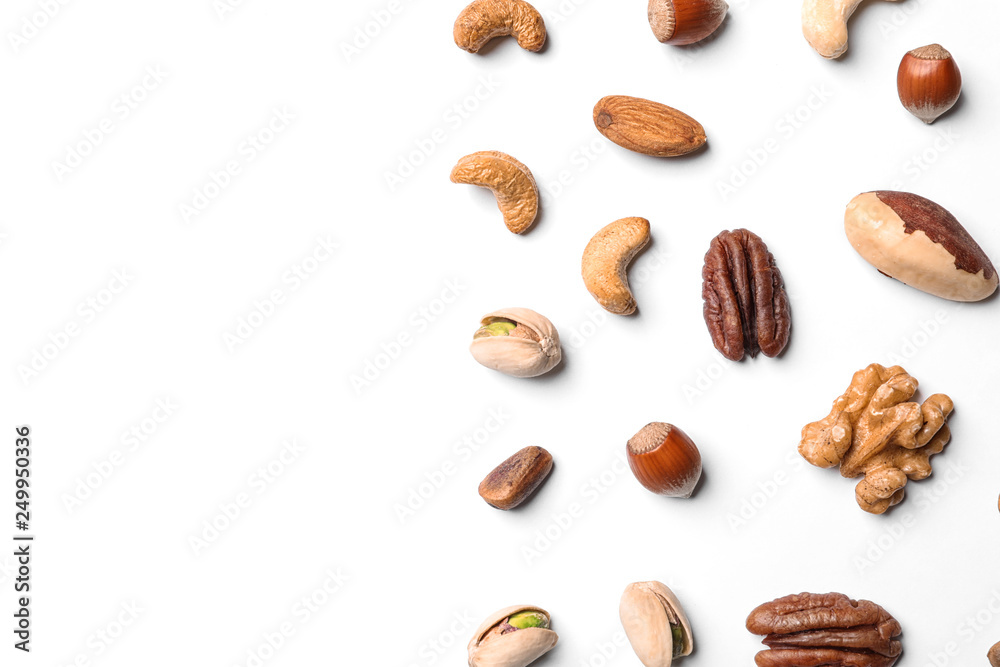 Composition with organic mixed nuts on white background, top view. Space for text