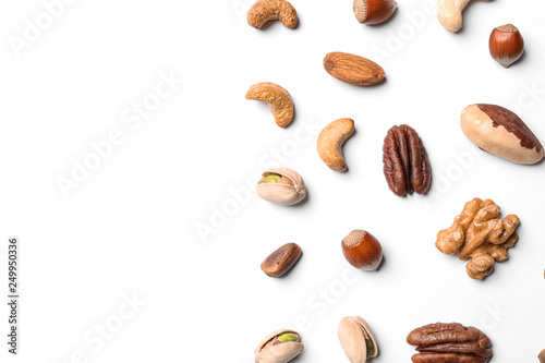 Composition with organic mixed nuts on white background  top view. Space for text
