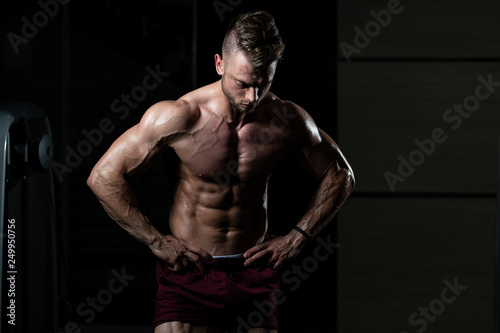 Handsome Muscular Man Flexing Muscles In Gym © Jale Ibrak