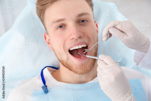 Dentist examining patient s teeth in modern clinic