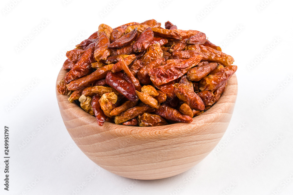 piri piri pepper in wooden bowl isolated on white background. piri piri pepper in wooden bowl isolated on white background.