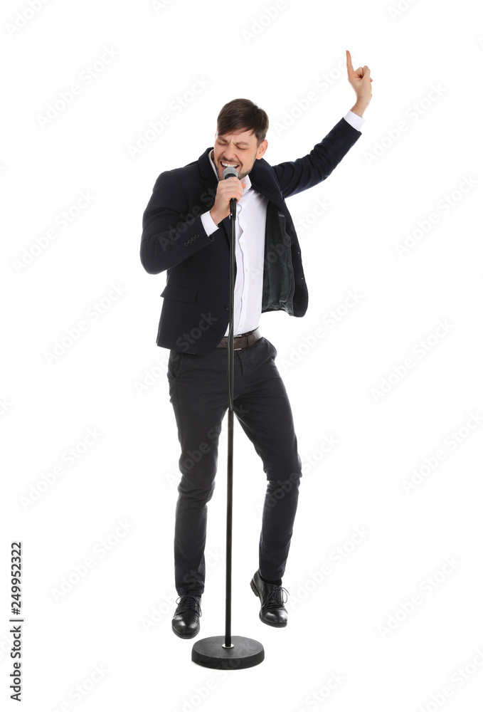 Handsome man in suit singing with microphone on white background