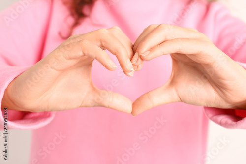 African-American woman making heart with her hands, closeup