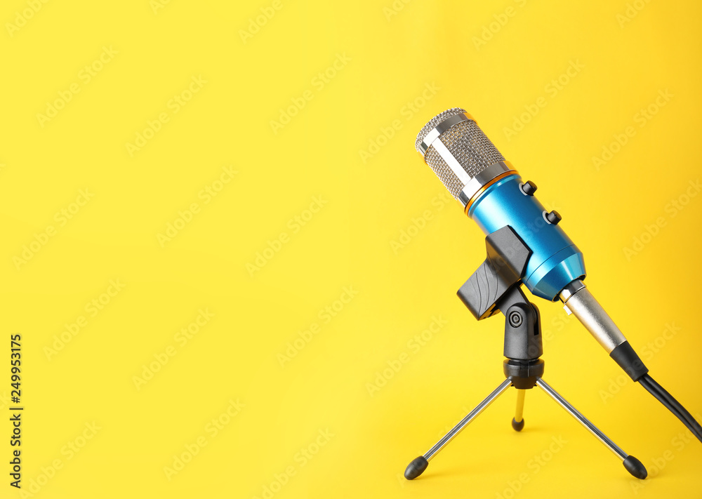 Fototapeta premium Condenser microphone on color background, space for text