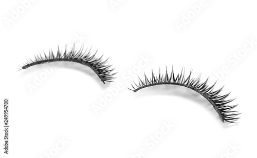 Beautiful pair of false eyelashes on white background