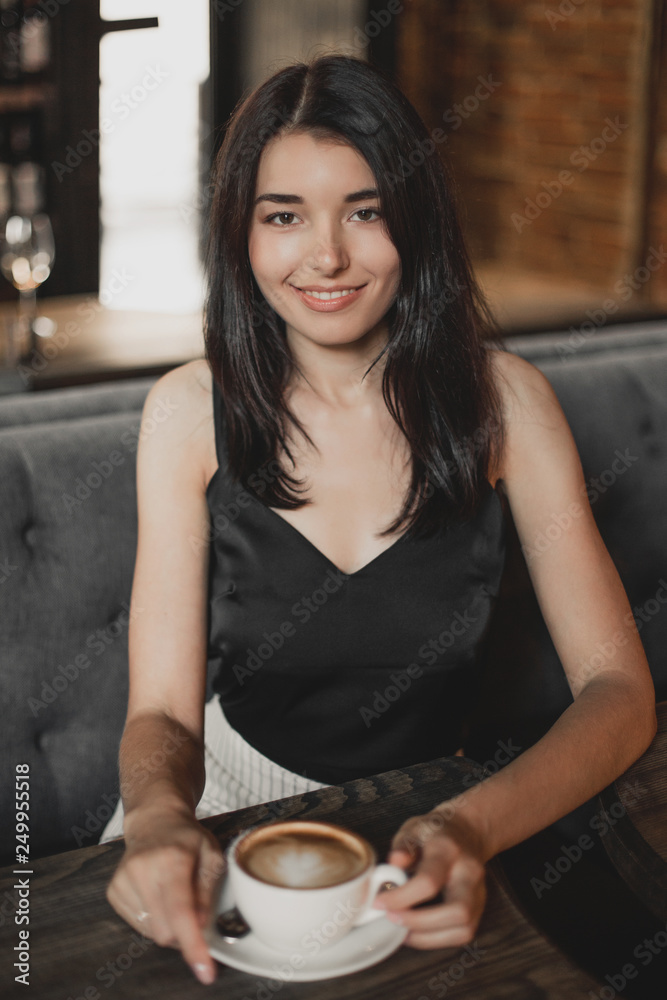 Beautiful woman drinking coffee sitting in a cafe. Beautiful woman drinking coffee sitting in a cafe.