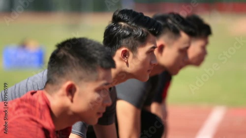 young asian sprinters on starting line photo