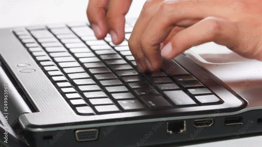 man's hands printing text on laptop keyboard - change in focus man's hands printing text on laptop keyboard - change in focus