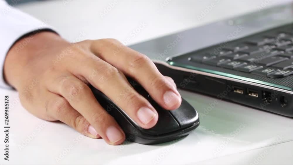 closeup of a businessman using laptop is typing on the keyboard and use the mouse. closeup of a businessman using laptop is typing on the keyboard and use the mouse.