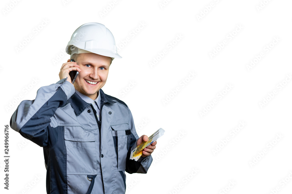 A happy construction worker counts money. An engineer in a white helmet is talking on the phone and is happy with the salary. Isolated A happy construction worker counts money. An engineer in a white helmet is talking on the phone and is happy with the salary. Isolated