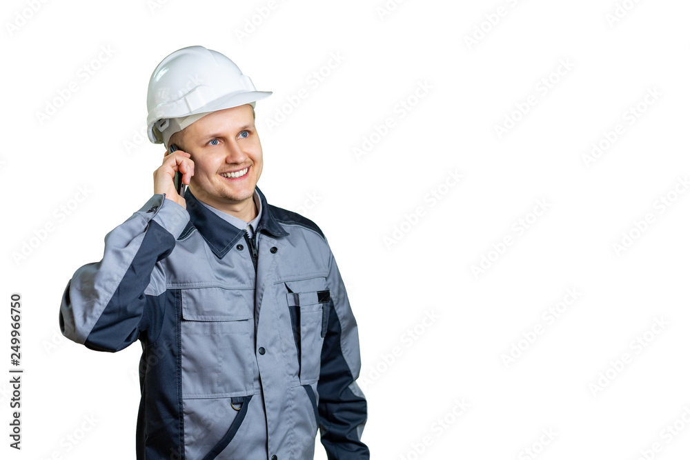 The builder is talking to someone on the phone. The working man pondered something good. The future is in our hands. Isolated The builder is talking to someone on the phone. The working man pondered something good. The future is in our hands. Isolated
