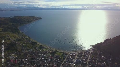 Flight over the lake Titikaka and town Copacobana at sunset. Bolivia photo