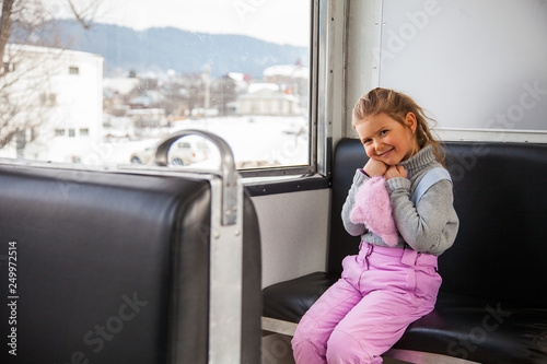 Little girl travelling by old train Kukushka between Borjomi and Bakuriani in Georgia photo