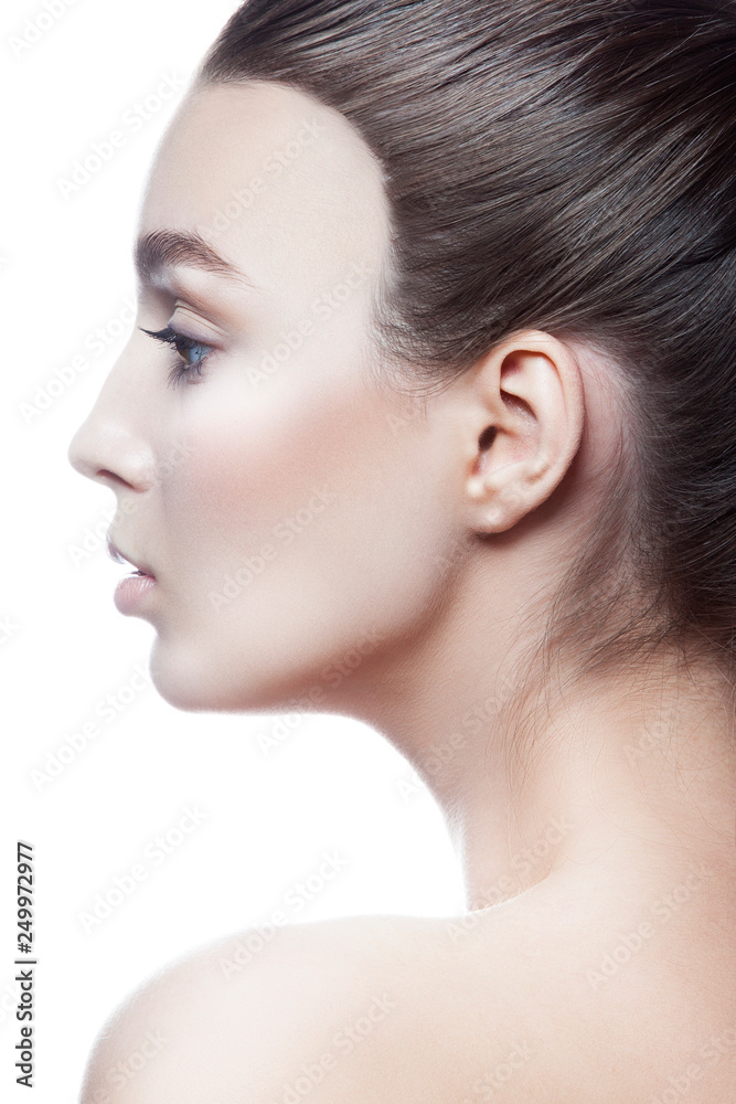 Close-up beauty face profile of young caucasian attractive fashion model girl. Nude natral make-up, clean fresh skin. Facial treatment concept. White background Close-up beauty face profile of young caucasian attractive fashion model girl. Nude natral make-up, clean fresh skin. Facial treatment concept. White background