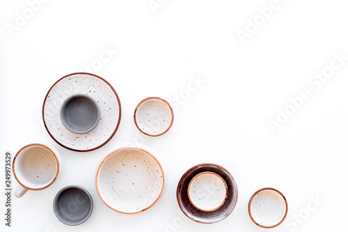 Ceramic tableware pattern. Empty plates and mugs on white background top view space for text