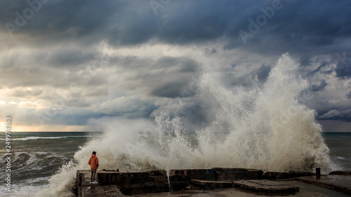 Storm waves over a pier in the Adler, Sochi