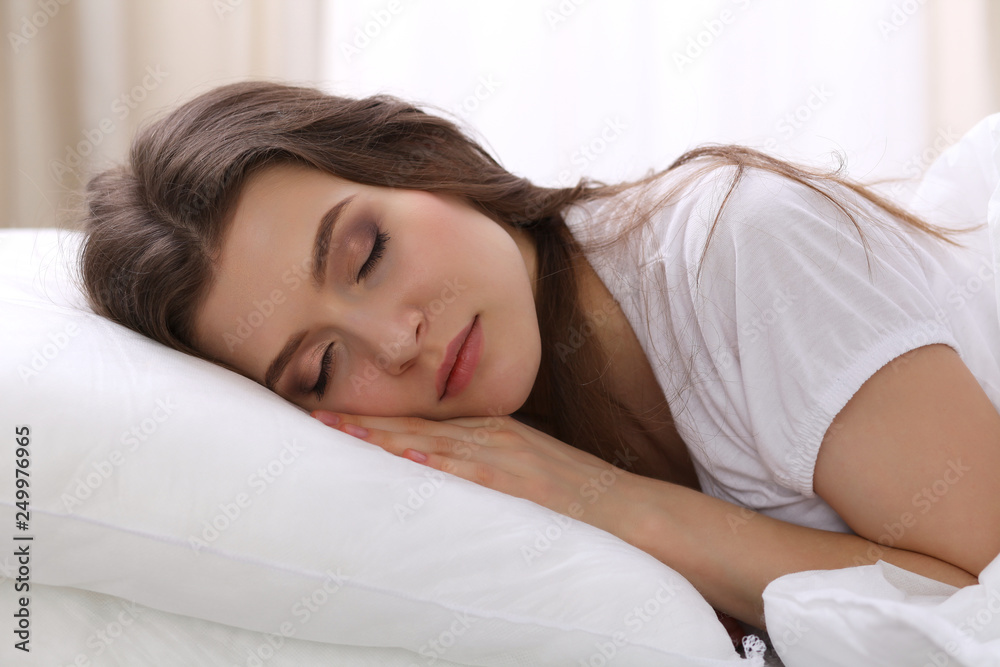 Beautiful young woman sleeping while lying in her bed. Concept of pleasant and rest reinstatement for active life Beautiful young woman sleeping while lying in her bed. Concept of pleasant and rest reinstatement for active life