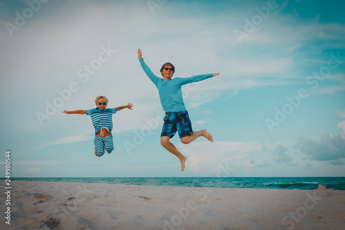 happy father and son have fun at beach, family jump on sand