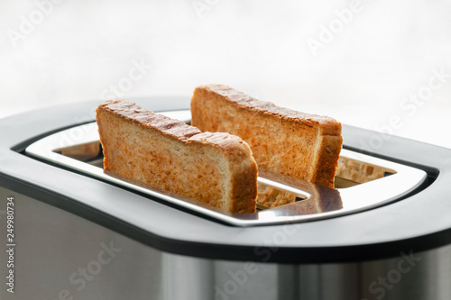 Healthy fashion food of breakfast. Toast in a toaster. Toaster with tasty breakfast toasts on the table