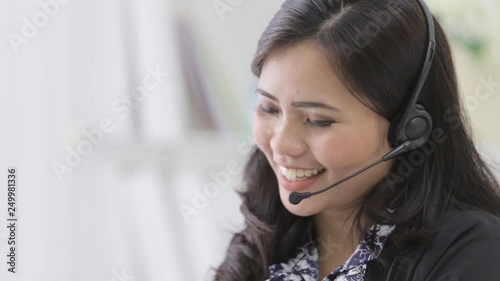 happy smiling call center operator answering phone using headphone