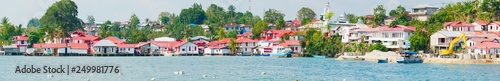 Red and white village at Tual, Kei Kecil island, Moluccas. A colorful slum called Kampung Merah Putih, colors of Indonesia national flag. High resolution panorama.
