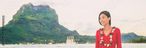 Fotografie, Obraz Bora bora French Polynesia Tahiti landscape with mt Otemanu and luxuy cruise ship in background of Asian woman tourist relaxing enjoying honeymoon sunset
