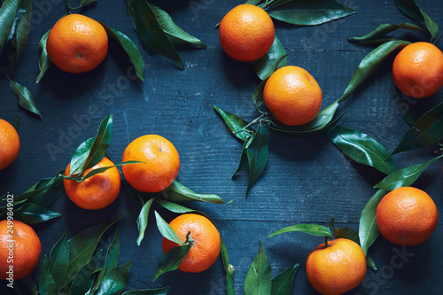 Fresh tangerines with stems and leaves photo