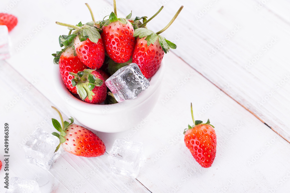 Fresh strawberries in a bowl on wooden table Fresh strawberries in a bowl on wooden table