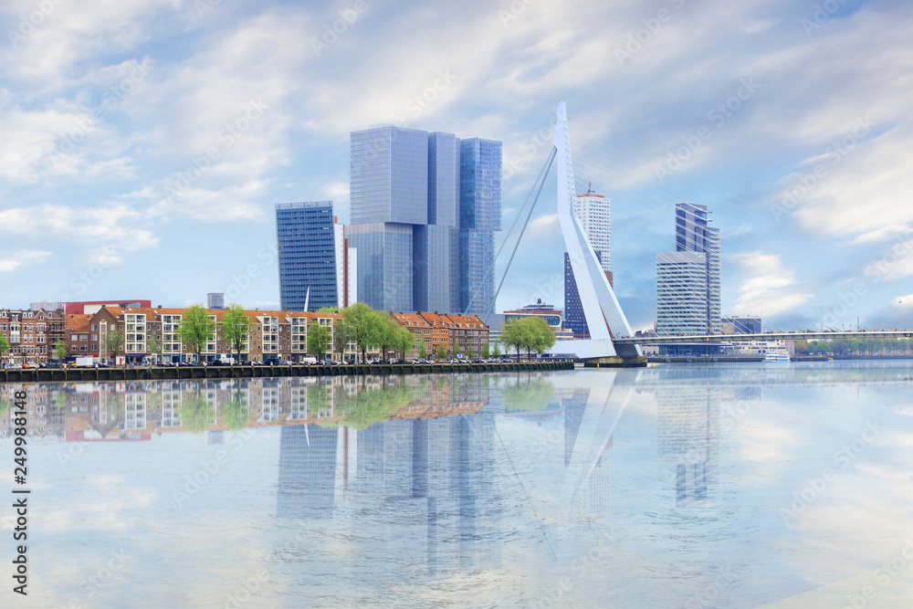 Waterfront panorama of Erasmus bridge across new meuse, theatre, headquaters, port center of Rotterdam Waterfront panorama of Erasmus bridge across new meuse, theatre, headquaters, port center of Rotterdam