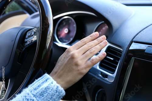 Woman checking operation of air conditioner in car © Pixel-Shot