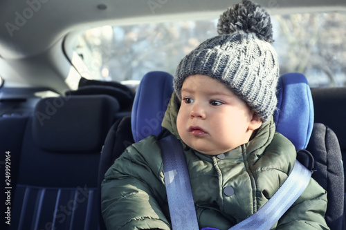 Baby boy buckled in car seat