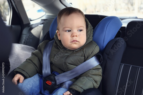 Baby boy buckled in car seat