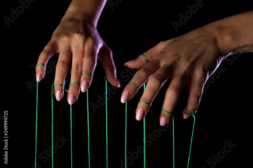 Hands of puppeteer on dark background