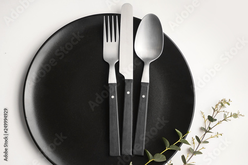 Silver cutlery with plate on table