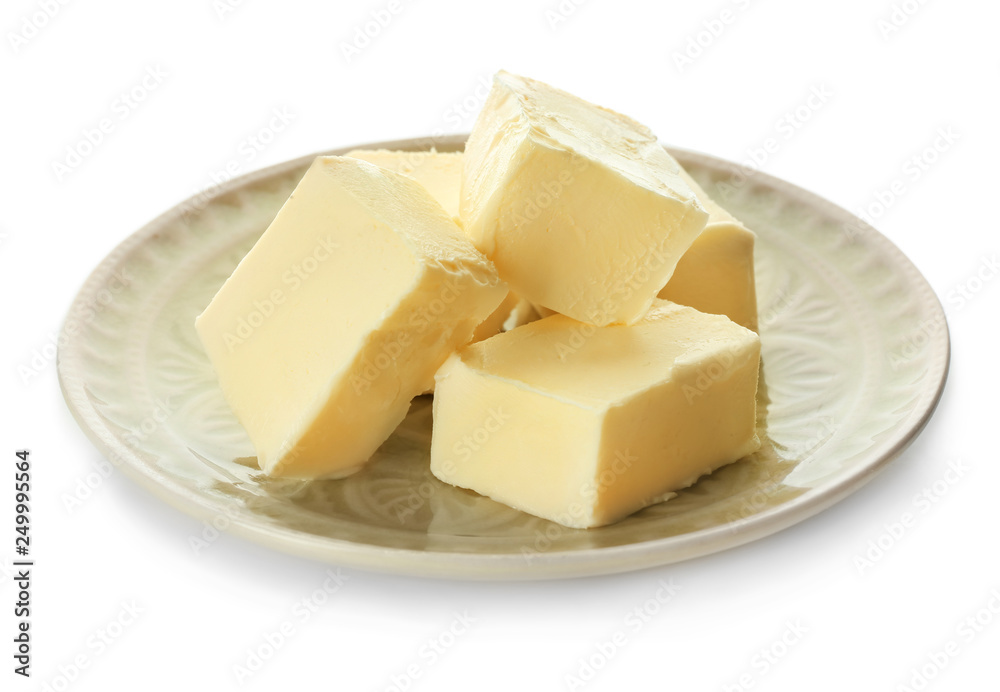 Plate with pieces of butter on white background