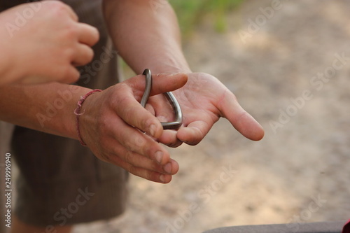A man holding a copper snake in his hands © kasanea