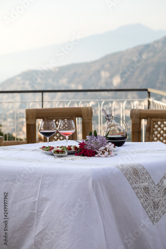 Table on the terrace prepared for a romantic dinner overlooking the Gulf of Naples and Mount Vesuvius © wjarek