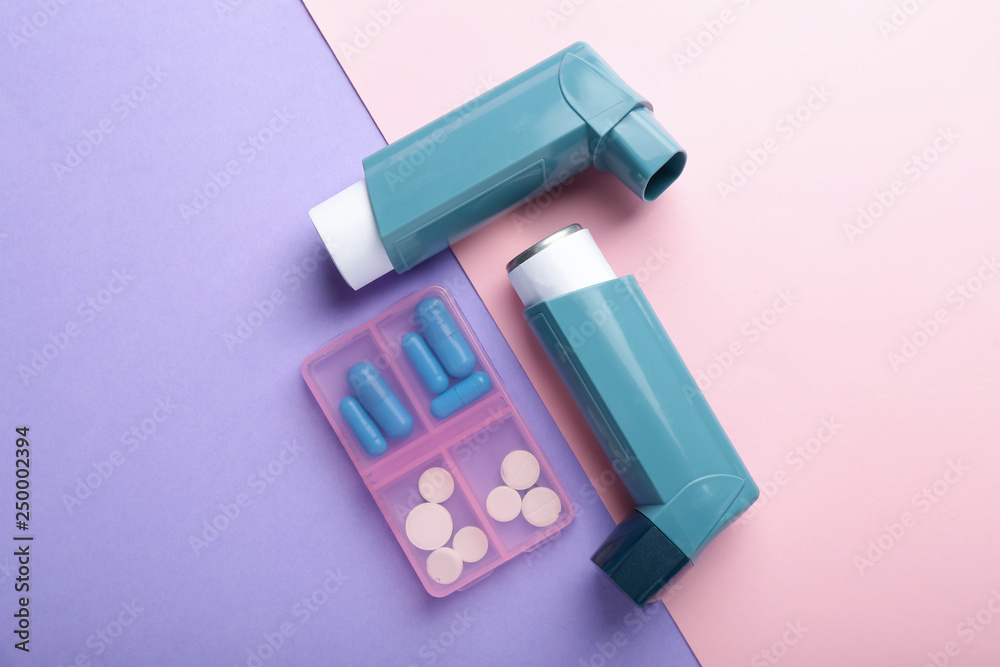 Inhalers and pills on color background Inhalers and pills on color background