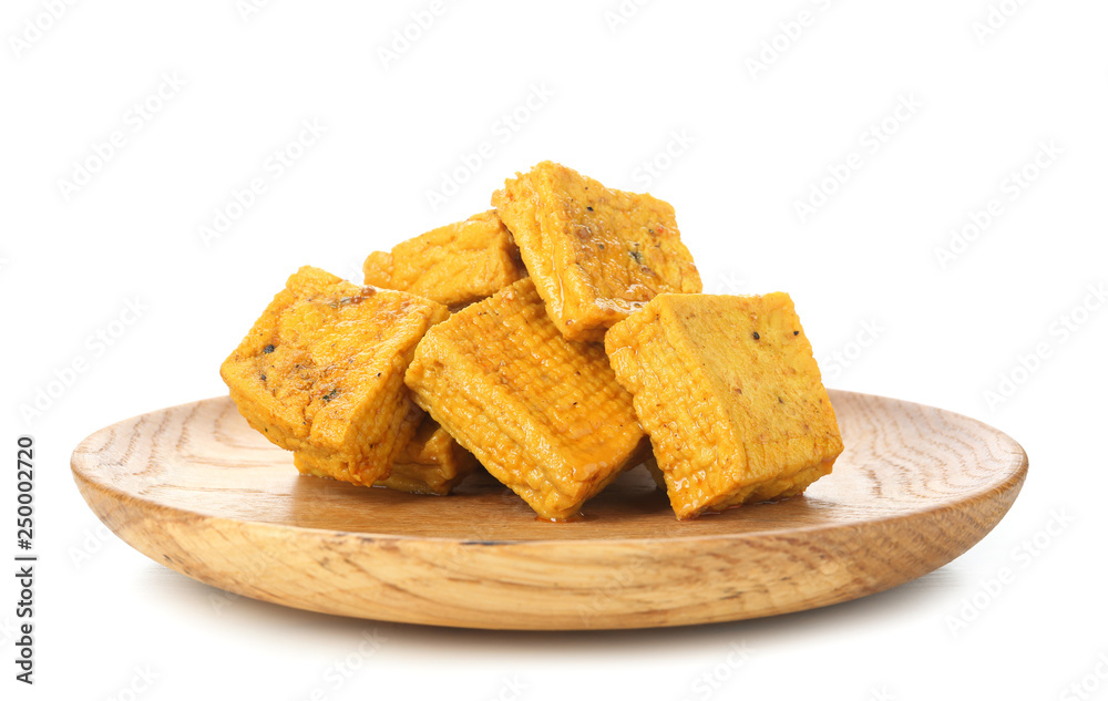Wooden plate with tasty tofu cheese on white background Wooden plate with tasty tofu cheese on white background