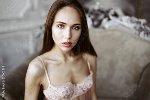 Fashionable female portrait of cute lady in pink bra indoors