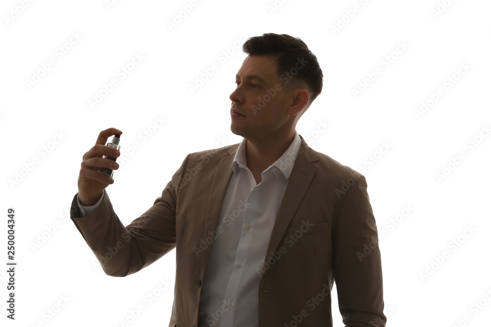 Handsome businessman with bottle of perfume on light background Handsome businessman with bottle of perfume on light background