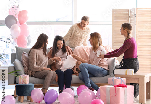 Pregnant woman with her friends at baby shower party